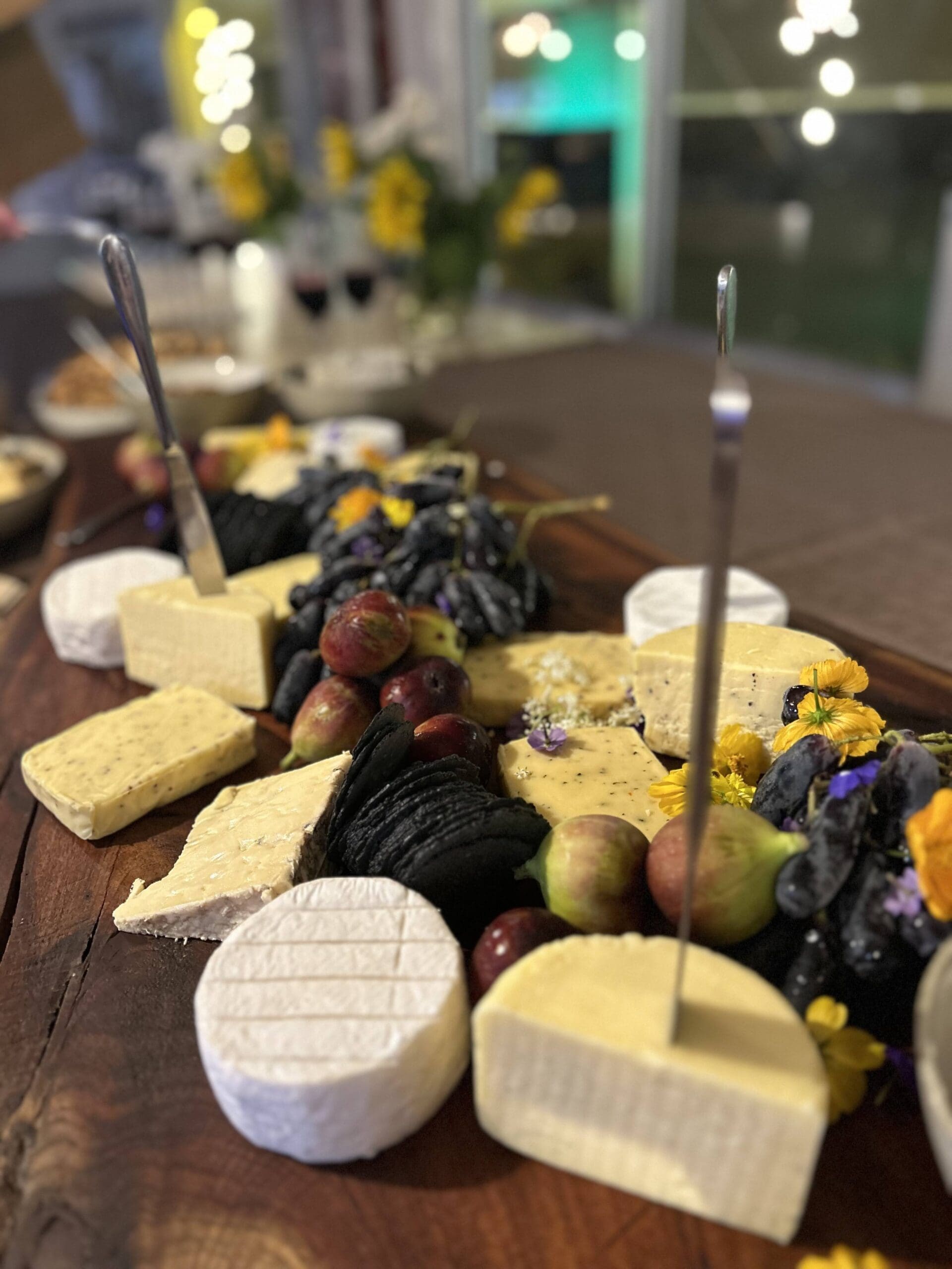 Spread of cheese and fruit on a board - Thistle in the Woods Catering